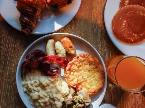 a table with a plate of food with breakfast foods at Novotel Luxembourg Centre in Luxembourg