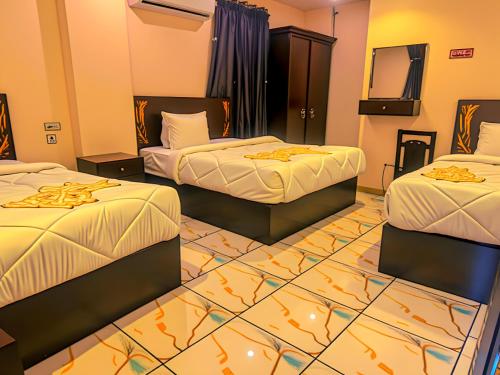 a hotel room with two beds and a television at Pyramids Sphinx VIEW Hotel in Cairo