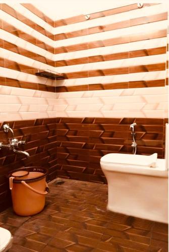a bathroom with a toilet and a sink at Aps inn munnar in Munnar