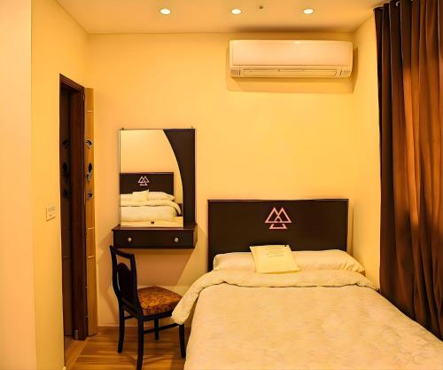 a bedroom with a bed and a mirror at Pyramids Sphinx VIEW Hotel in Cairo