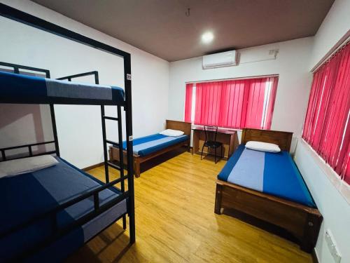 a room with two bunk beds and a desk at Havelock City Hostel, Colombo in Colombo