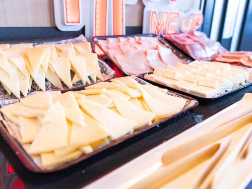 a display of cheese and meats on a table at Ibis Malaga Centro Ciudad in Málaga