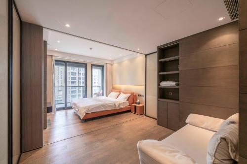 a bedroom with two beds and a window at ZHome-Deplex luxury apartment-Near The Bund in Shanghai