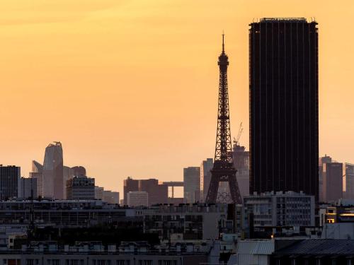 a view of a city with the eiffel tower at Novotel Paris 13 Porte d'Italie in Le Kremlin-Bicêtre