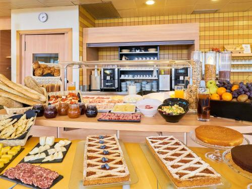 a buffet with many different types of food on a table at Ibis Como in Grandate