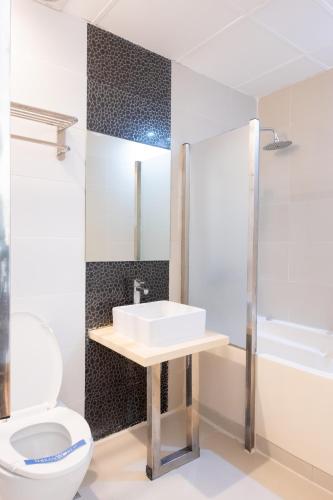 a bathroom with a sink and a toilet at Hotel Dreamworld Araneta Cubao in Manila