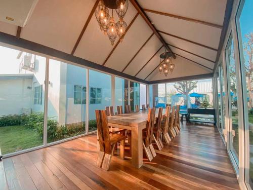 a dining room with a wooden table and chairs at Buffalo Island Resort & Adventure Park in Ban Pa Mak (1)