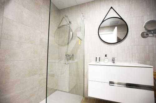 a bathroom with a shower and a sink and a mirror at Book Jet - Casilla de Costa Dreams in Villaverde