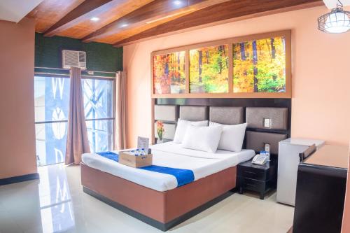 Ένα ή περισσότερα κρεβάτια σε δωμάτιο στο Hotel Dreamworld Araneta Cubao
