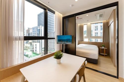 a room with a bed and a table with a tv at MSstay Myeongdong in Seoul