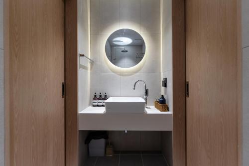 a bathroom with a sink and a mirror at MSstay Myeongdong in Seoul