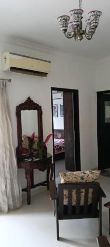 a room with a mirror and a chair and a table at Premium Luxury -1BHK at Candolim Beach with Free Wifi and Pool in Candolim