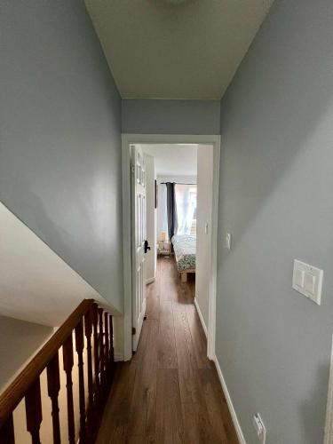 an empty hallway with blue walls and a staircase at DT Townhome 1BR steps to transit in Toronto