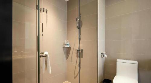a bathroom with a shower and a toilet at City Comfort Inn Shiyan Wudang Mountain in Danjiangkou