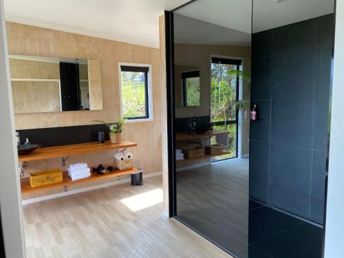 a bathroom with a shower with a glass door at Whakaipo Bay Cabin Retreat Taupo in Taupo