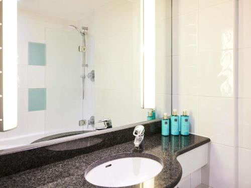 a bathroom with a sink and a shower at Novotel Bristol Centre in Bristol