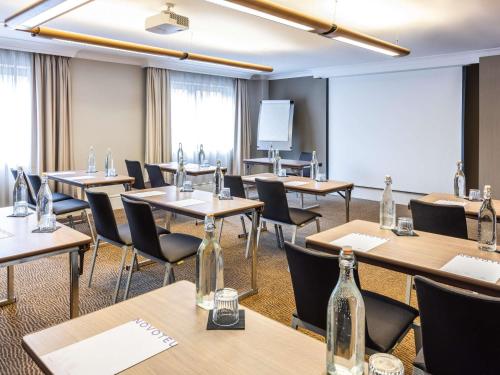 a conference room with tables and chairs and bottles at Novotel Bristol Centre in Bristol