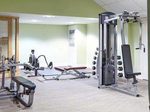 a gym with several tread machines in a room at Novotel Bristol Centre in Bristol