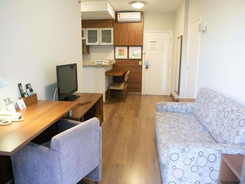 a living room with a couch and a table at Mercure Sao Caetano do Sul in São Caetano do Sul