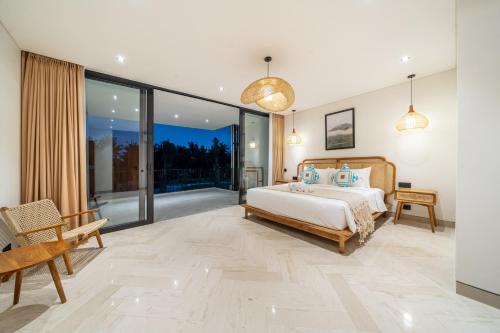 a bedroom with a bed and sliding glass doors at Townhouse T1 - Hidden Gem in Ubud -Townhouse in Ideal Location in Ubud