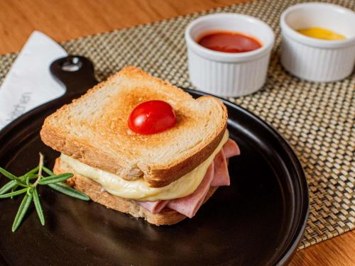 a sandwich on a plate on a table with ketchup at ibis Joinville in Joinville