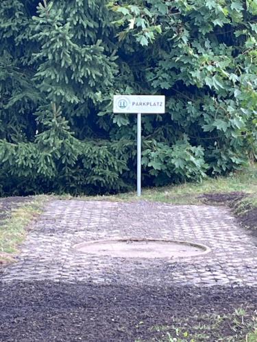 a sign in the middle of a brick road at NEU! Vogtland Herberge Grünbach in Grünbach