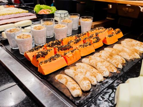 a buffet line with sushi and other food items at ibis Joinville in Joinville