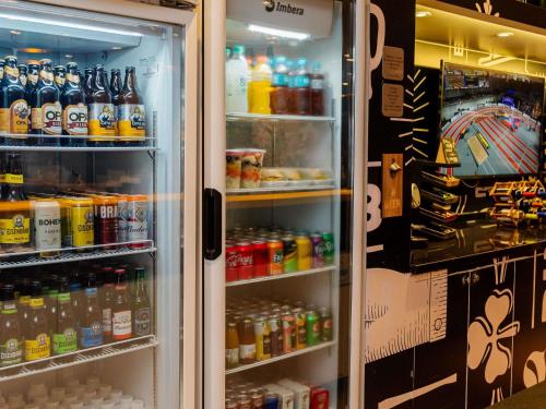 an open refrigerator filled with lots of drinks at ibis Joinville in Joinville