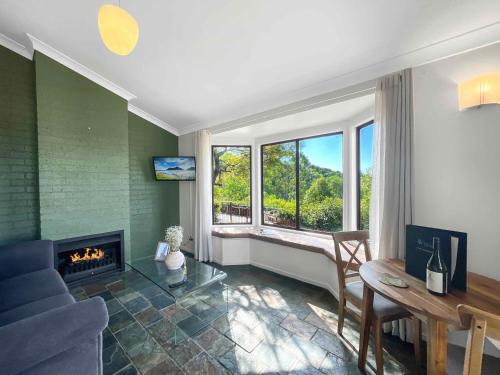 a living room with a couch and a fireplace at Bimbadeen Estate Villa 2 in Mount View