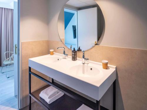 a bathroom with a white sink and a mirror at ibis Styles Deauville Villers Plage in Villers-sur-Mer
