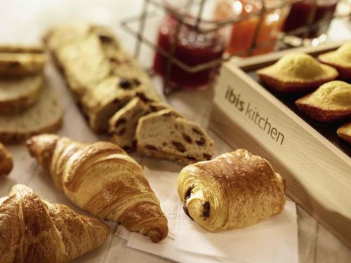 a group of breads and pastries on a table at ibis Honfleur in Honfleur