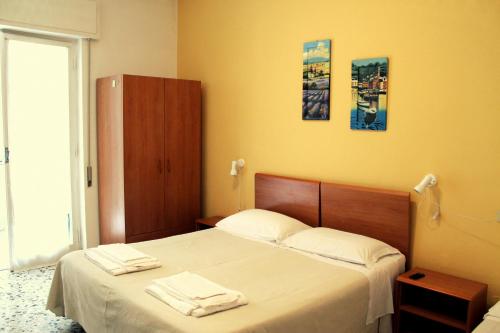 Postel nebo postele na pokoji v ubytování Albergo Nella