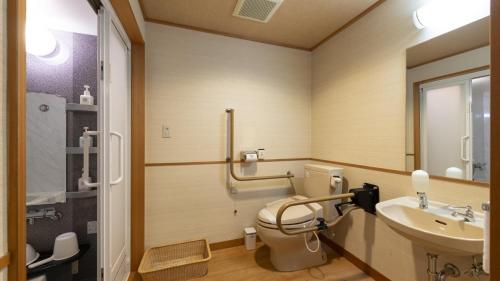 a bathroom with a toilet and a sink at Hotel Symphony Annex Sagae Onsen in Sagae