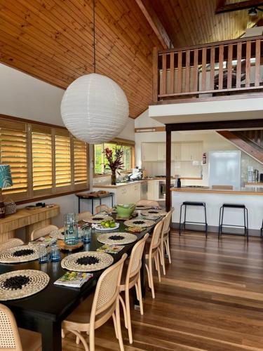 a dining room with a table and chairs in a kitchen at Loloma! Luxe 4 bed, 2 bath Villa in Yamba