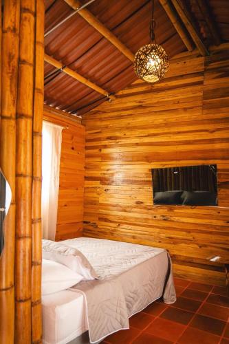 a bedroom with two beds in a wooden cabin at Cabañas Viva Mexico in Ibagué