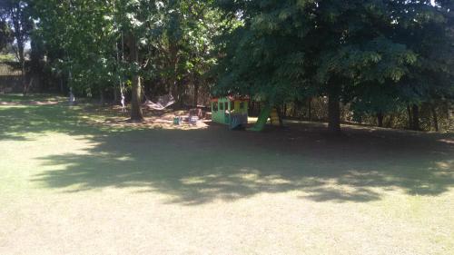 a playground in a park with trees and a small childs train at La Dolce Casetta in Grottaferrata
