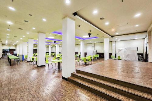 a room with a dance floor and tables and chairs at Whinstone Hotel & Resort in Jeju