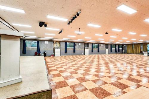 a large room with a checkered floor and lights at Whinstone Hotel & Resort in Jeju