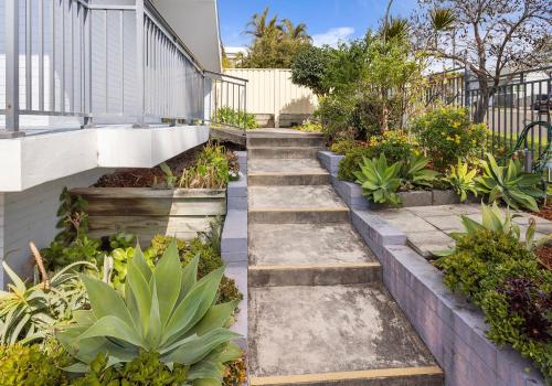 a garden with concrete steps and plants at Bombo Breeze in Kiama
