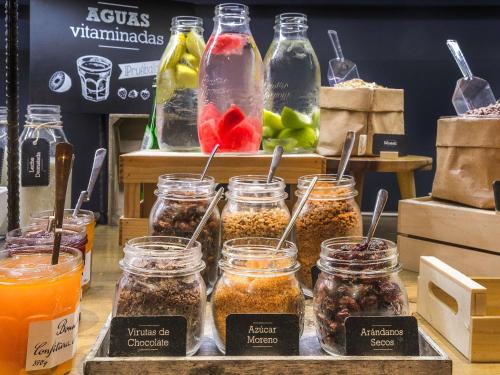 a display of jars of food on a table at ibis Porto Alegre Aeroporto in Porto Alegre