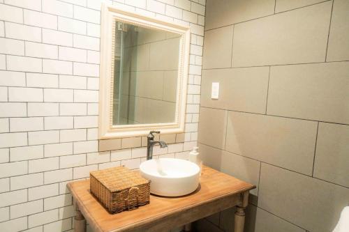 a bathroom with a sink and a mirror at Chu Mansion - Chill & Grill and Pickeball in Da Thien