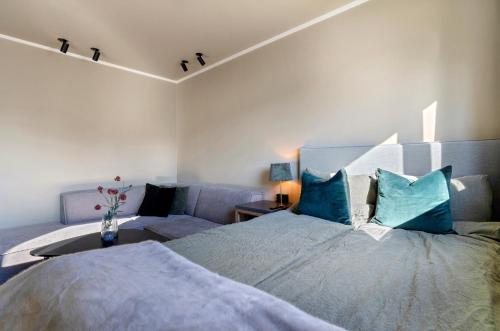 a bedroom with a large bed and a couch at Premium Studio by Arctic Seasons - A Cozy Luxury Escape at the Top of Tromsø in Tromsø