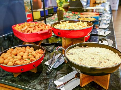 a buffet filled with different types of food in bowls at ibis Rio de Janeiro Santos Dumont in Rio de Janeiro