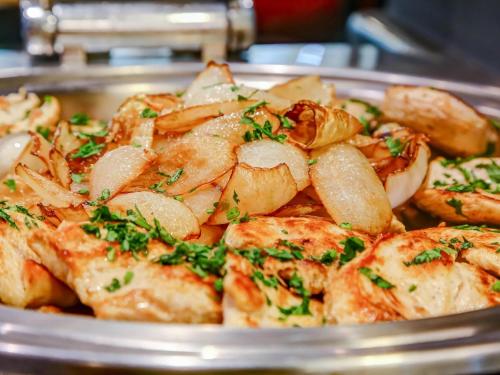 a plate of food with potatoes and herbs on it at ibis Rio de Janeiro Santos Dumont in Rio de Janeiro