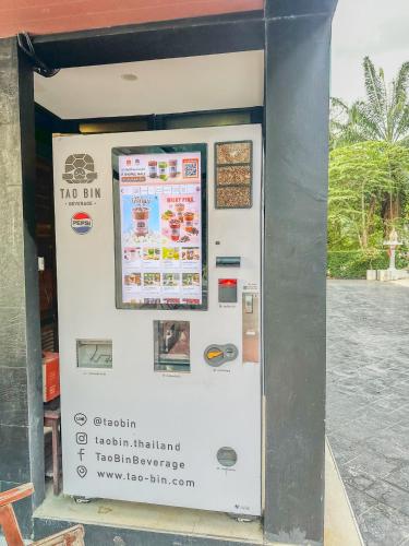 a vending machine with a sign on the side of it at The Viva Patong in Patong Beach