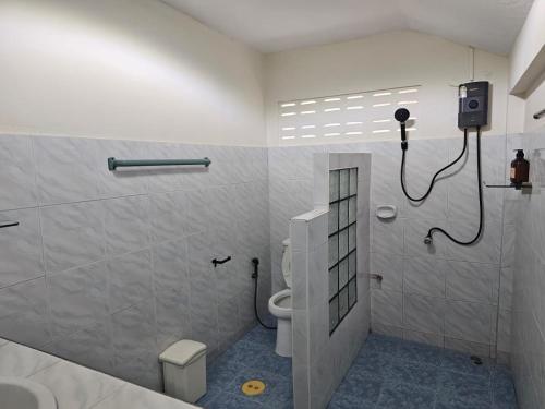 a bathroom with a shower and a toilet in it at Friends Retreat Phuket in Ban Bo Han