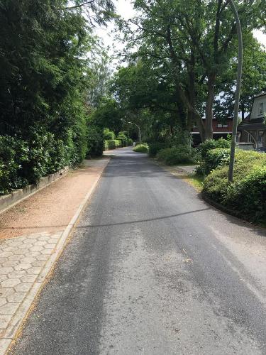 an empty road with trees on the sides of it at Bed & Breakfast Bigalke in Hamburg