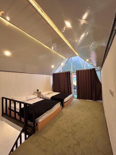 Ένα ή περισσότερα κρεβάτια σε δωμάτιο στο Lotus sikunir dieng