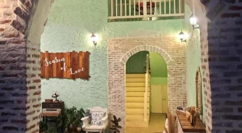 a room with a brick wall and a balcony at Charisma Resort in Ratchaburi