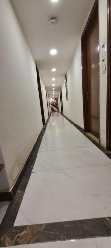 an empty hallway with a door and a white floor at SBS Hotel Underbridge in Jāmb